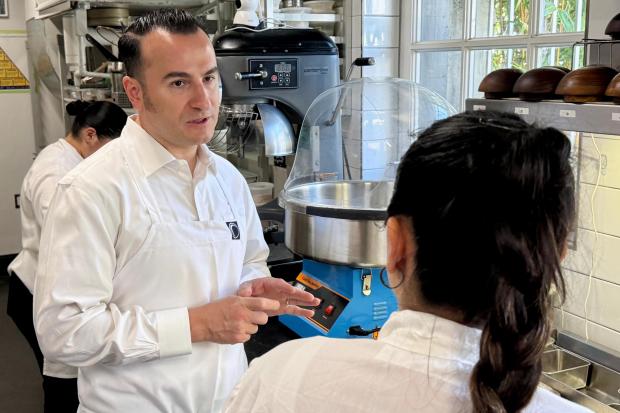Chef Val Cantu, co-owner of Californios, speaks with a member of the staff in San Francisco on Thursday, July 16, 2026. (AP Photo/Haven Daley)