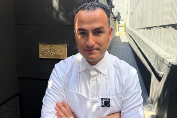 Chef Val Cantu, co-owner of Californios, poses in front of his three Michelin Star plaque in San Francisco on Thursday, July 16, 2026. (AP Photo/Haven Daley)