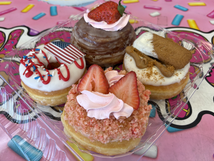 an assortment of donuts with toppings