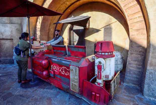 A visitor to Star Wars: Galaxy's Edge buys a thermal detonator-style soda from a droid-themed stand at Disneyland in Anaheim, CA, on Thursday, Dec 5, 2019. (Photo by Jeff Gritchen, Orange County Register/SCNG)