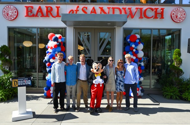 Luke Montagu, 12th Earl of Sandwich, stands with Mickey Mouse and his wife Julie Montagu, Countess of Sandwich, along with their kids, Jack Montagu, left William Montagu, Emma Fisher and Nestor Montagu, right, during the opening of Earl of Sandwhich at Downtown Disney in Anaheim, CA, on Wednesday, July 15, 2026. (Photo by Jeff Gritchen, Orange County Register/SCNG)