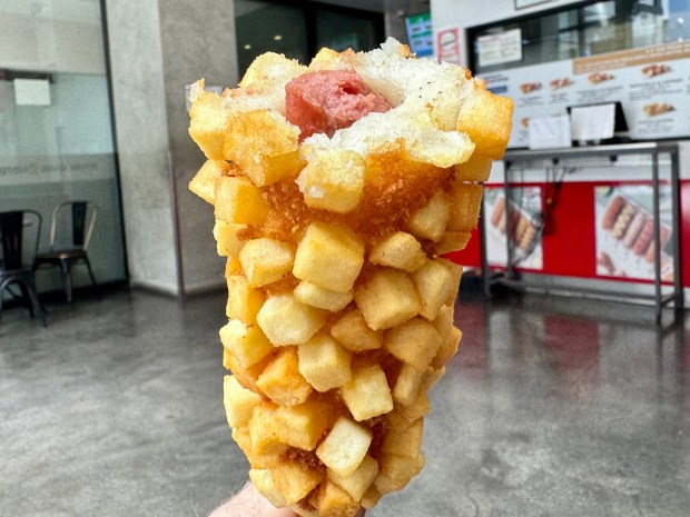 The Korean-style corndog at Myungrang Hot Dog, with locations in Buena Park and Garden Grove, is rolled in crispy cubed potatoes and fried golden brown. (Photo by Brock Keeling, Orange County Register/SCNG)