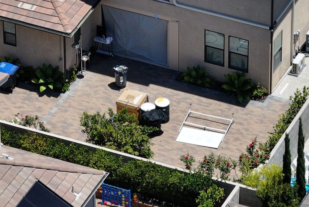 What appears to be 55-gallon drums and a whiteboard sit in the backyard where police and the FBI are responding to a call about a chemical odor coming from a home on Crater in the Altair neighborhood of Irvine on Thursday, July 9, 2026. (Photo by Jeff Gritchen, Orange County Register/SCNG)