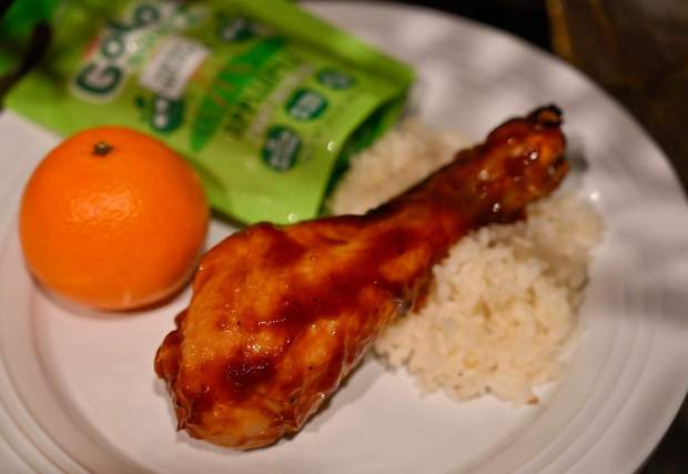 Roasted chicken drumstick with sweet bbq sauce and heirloom rice served with a mandarin orange and applesauce with choice of small water or small lowfat milk will be available on the kids menu at the new Tiana's Palace Restaurant at Disneyland in Anaheim, CA, on Tuesday, August 22, 2023. (Photo by Jeff Gritchen, Orange County Register/SCNG)