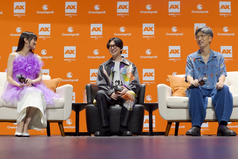 Voice actors speaking at a panel
