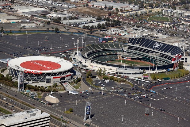 Oracle Arena (now known as Oakland Arena), left, and O.co Coliseum are seen in this aerial view over Oakland, Calif., on Wednesday, Oct. 8, 2014. (Jane Tyska/Bay Area News Group)