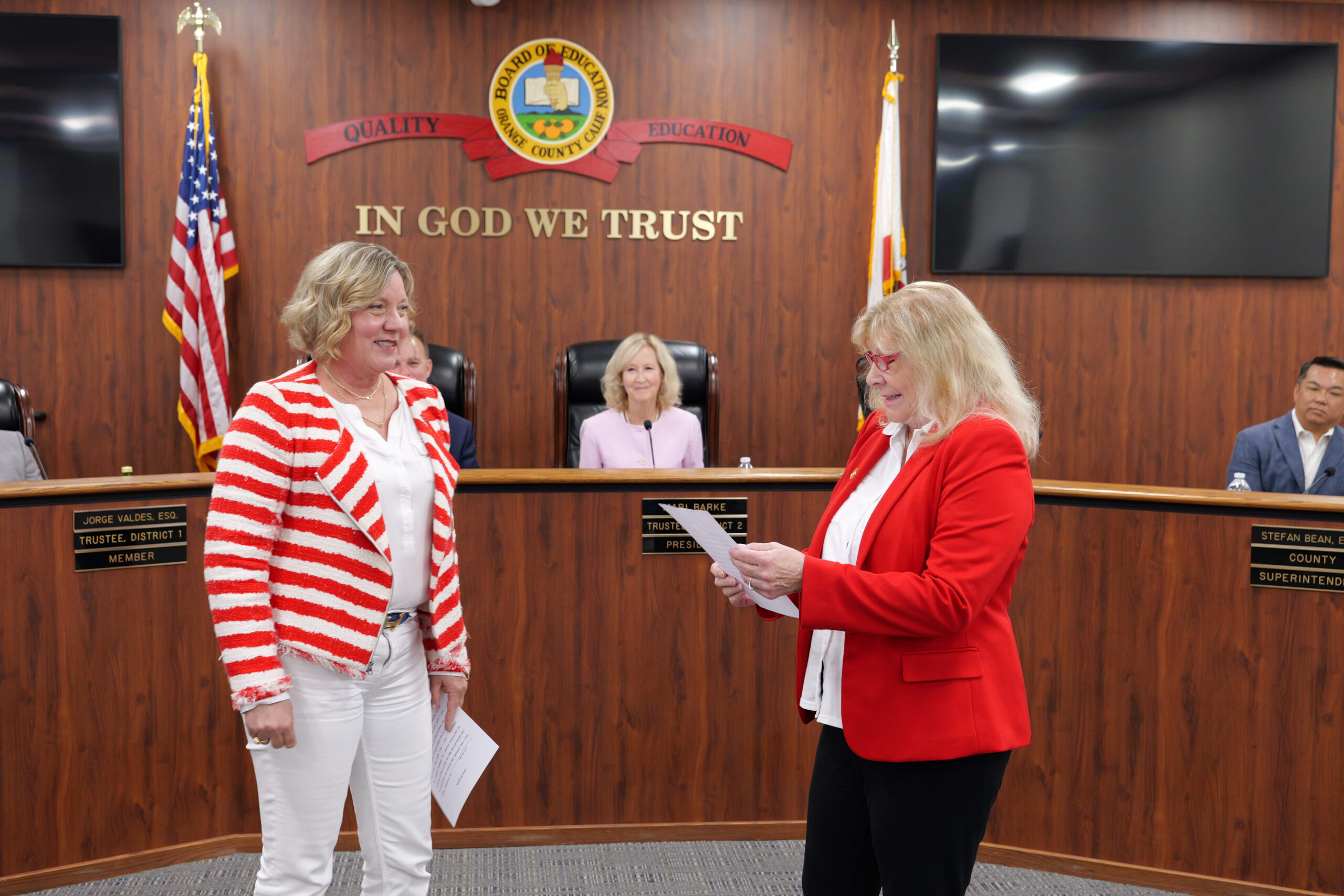 Former Orange County Board of Education Trustee Linda Lindholm administers the oath of office to Trustee Dr. Lisa Sparks during a board meeting.