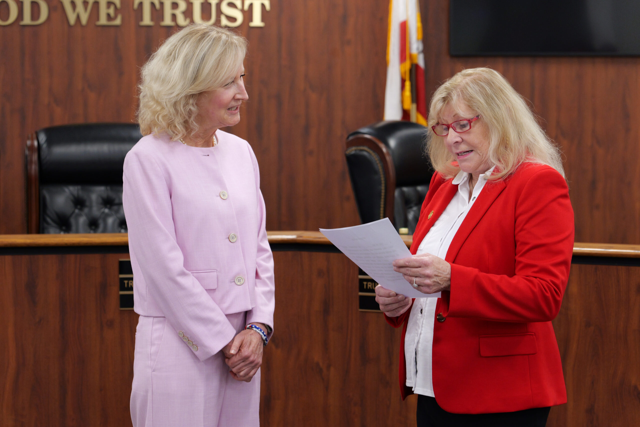 Former Orange County Board of Education Trustee Linda Lindholm administers the oath of office to Trustee Mari Barke during a board meeting.