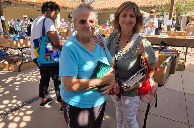 Rancho Bernardo resident Moralee Armstrong, left, shopped for soft cover fiction books with her daughter, Melissa Heinemann, at the Friends of the Poway Library's book sale. (Julie Gallant)