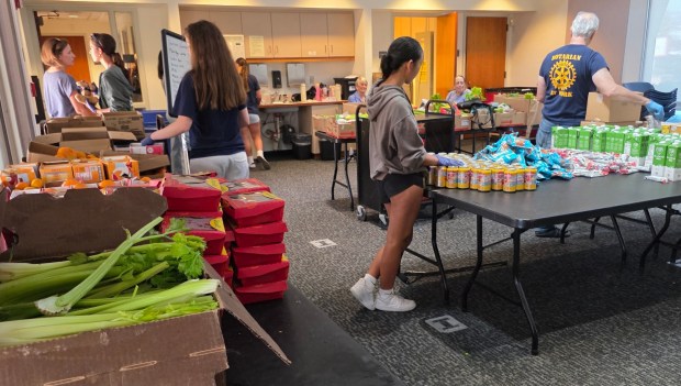 Free food is bundled into boxes before distribution from 3:30 to 5:30 p.m. on Wednesdays. (Julie Gallant)