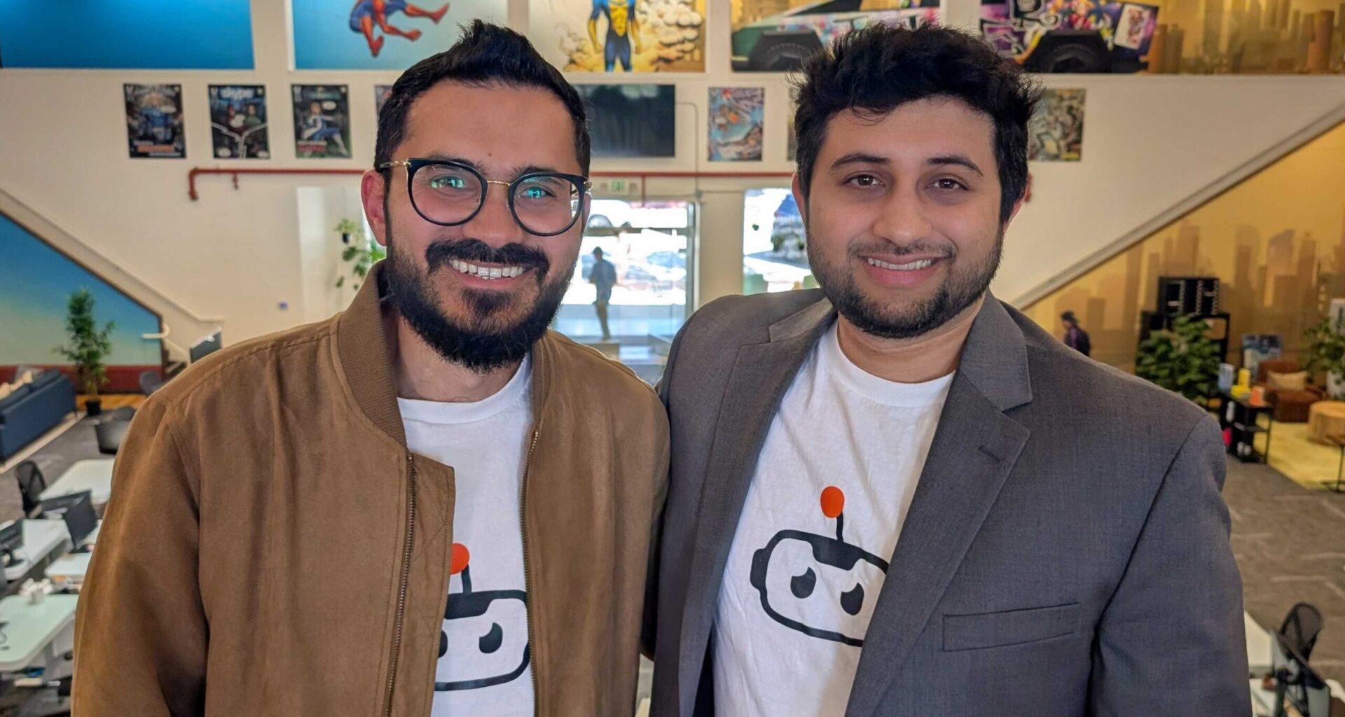 two men wearing logo tshirts and jackets