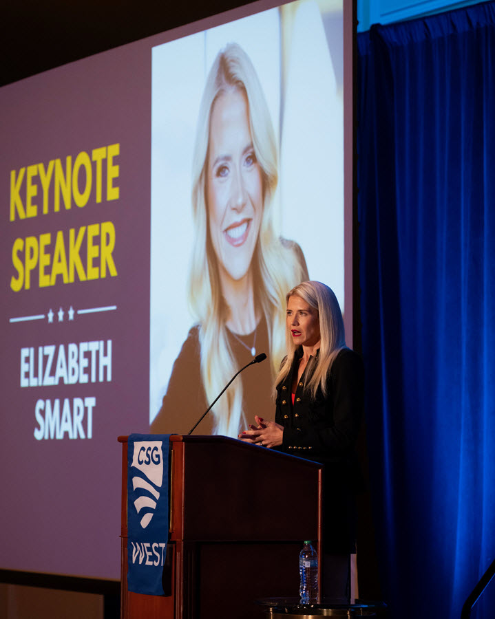 Elizabeth Smart speaking at podium on stage.