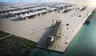 Artist's rendering of Saronic's planned Port Alpha shipyard in Brownsville, Texas, showing multiple construction halls, waterfront assembly areas, and large vessels under construction along the quay.