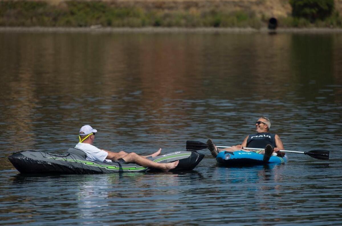 Mark Wilson of East Sacramento, left, relaxes in a kayak while floating in Lake Natoma with his friend Danny Langdon of Tahoe Park on Thursday, Aug. 3, 2017.