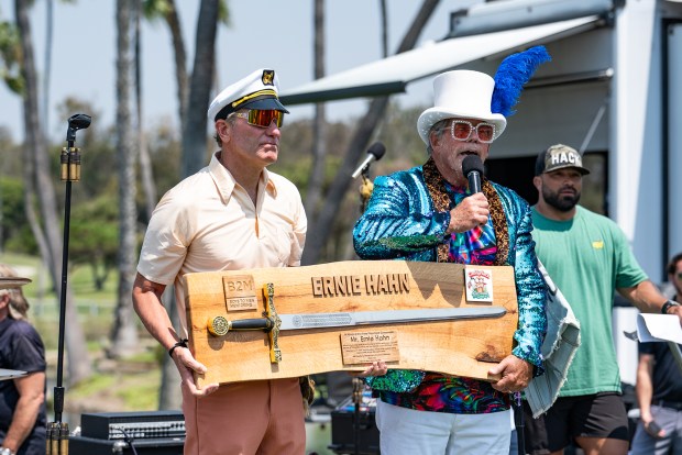 CaddyHack event founder Ernie Hahn receives 'Excalibur' Boys 2 Men award from 'Elton Joe' at the 2025 Caddyhack Golf Festival.(Jon Clark)