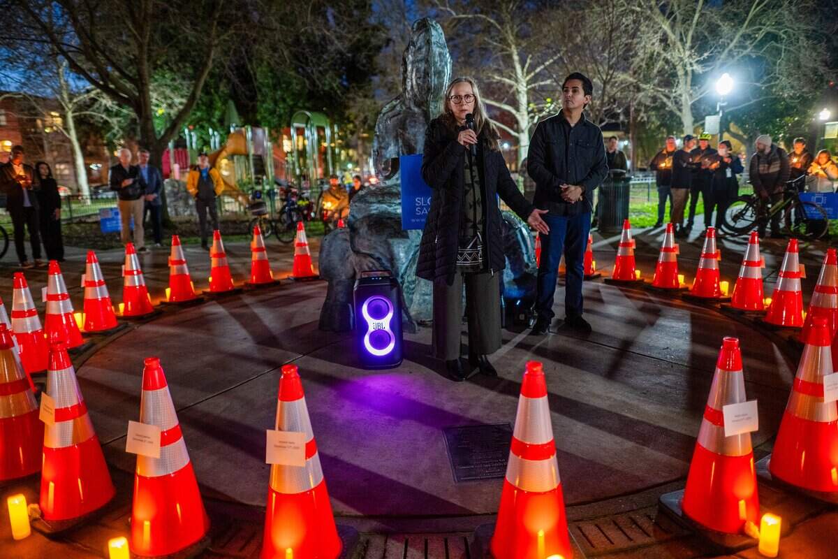 Michelle Silva speaks in January about the loss of her husband as she stands in front of a circle of cones representing people killed in Sacramento in 2025 by fatal vehicle crashes during a vigil at Fremont Park. Her husband, José Luis Silva, was struck by a truck while riding his motorcycle in midtown.