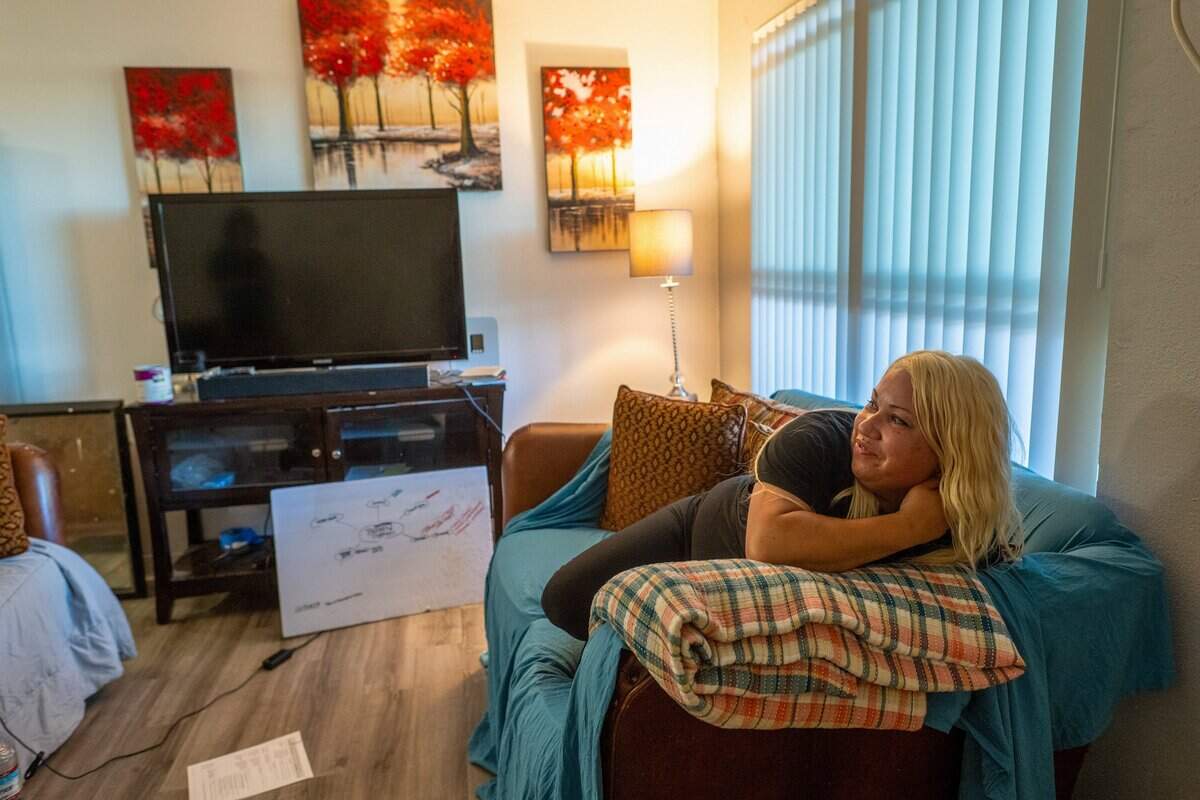 Jocelyn Wright, 40, who had been homeless for the past five years, relaxes inside her Rancho Cordova apartment on June 9. She moved into the $1,450 a month apartment in May. Wright said everything inside her apartment came from a woman she connected with on Nextdoor, who gave it to her for free.