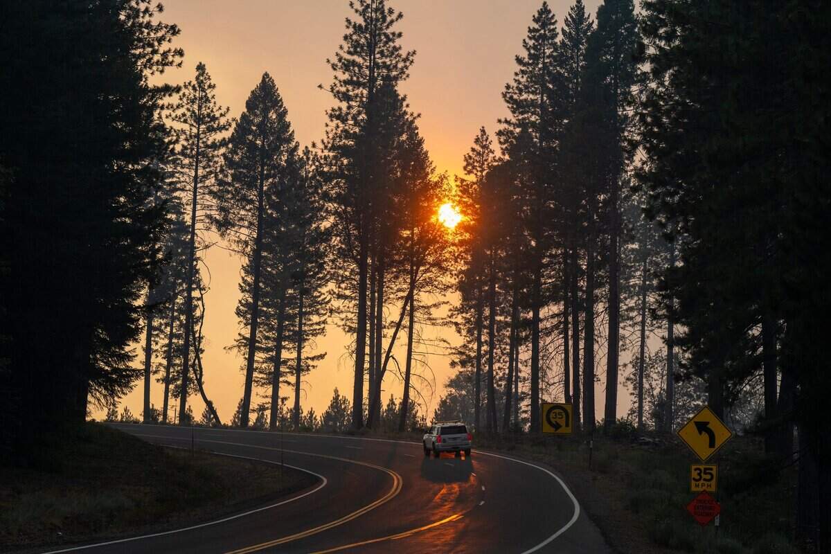 The sun shines through smoke from the Park Fire east of Chico on Highway 32 in 2024.