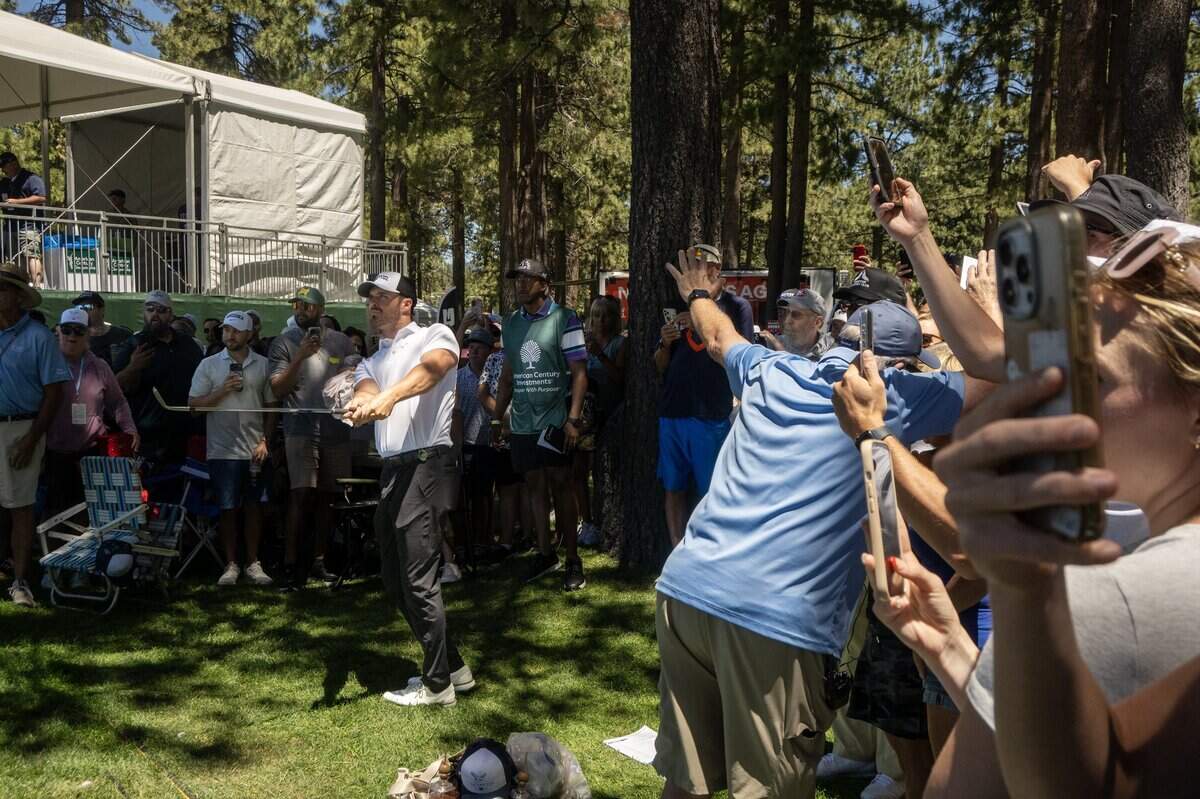 Fans watch former NFL quarterback Derek Carr hit out of the gallery on the 17th hole during the American Century Championship at Edgewood Tahoe Golf Course in Stateline, Nev., on Friday, July 10, 2026.
