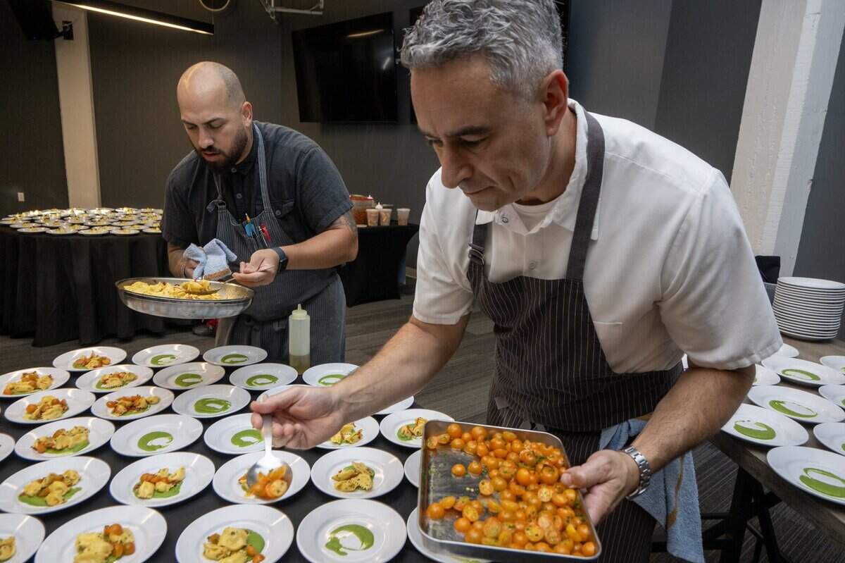 Hawks Public House chef Mike Fagnoni, right, and Francisco Rivera prepare sweet corn agnolotti with zucchini-basil purée, blistered cherry tomatoes and seasonal herbs during the Savor East Sac Chef's Challenge on Friday, July 24, 2026, in Sacramento.