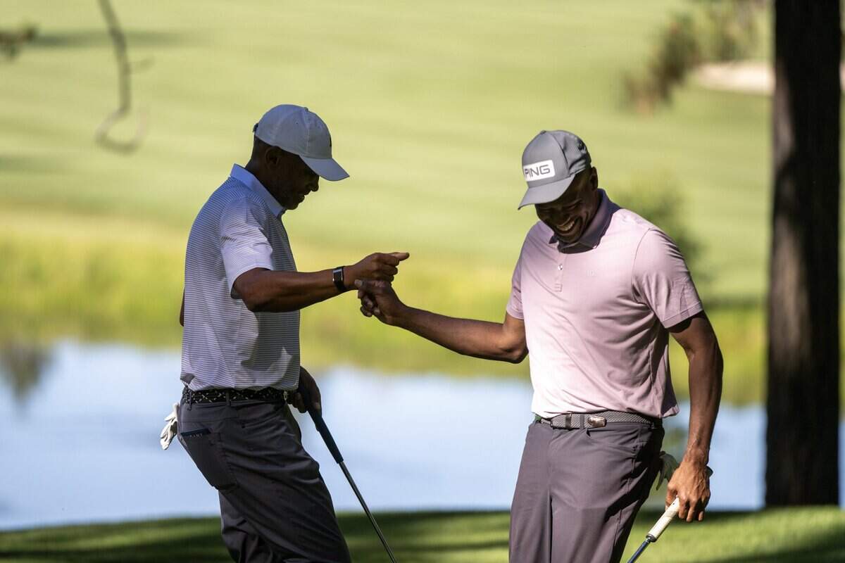 Former NBA players Grant Hill and Vince Carter react after making par during the American Century Championship at Edgewood Tahoe Golf Course in Stateline, Nev., on Friday, July 10, 2026.