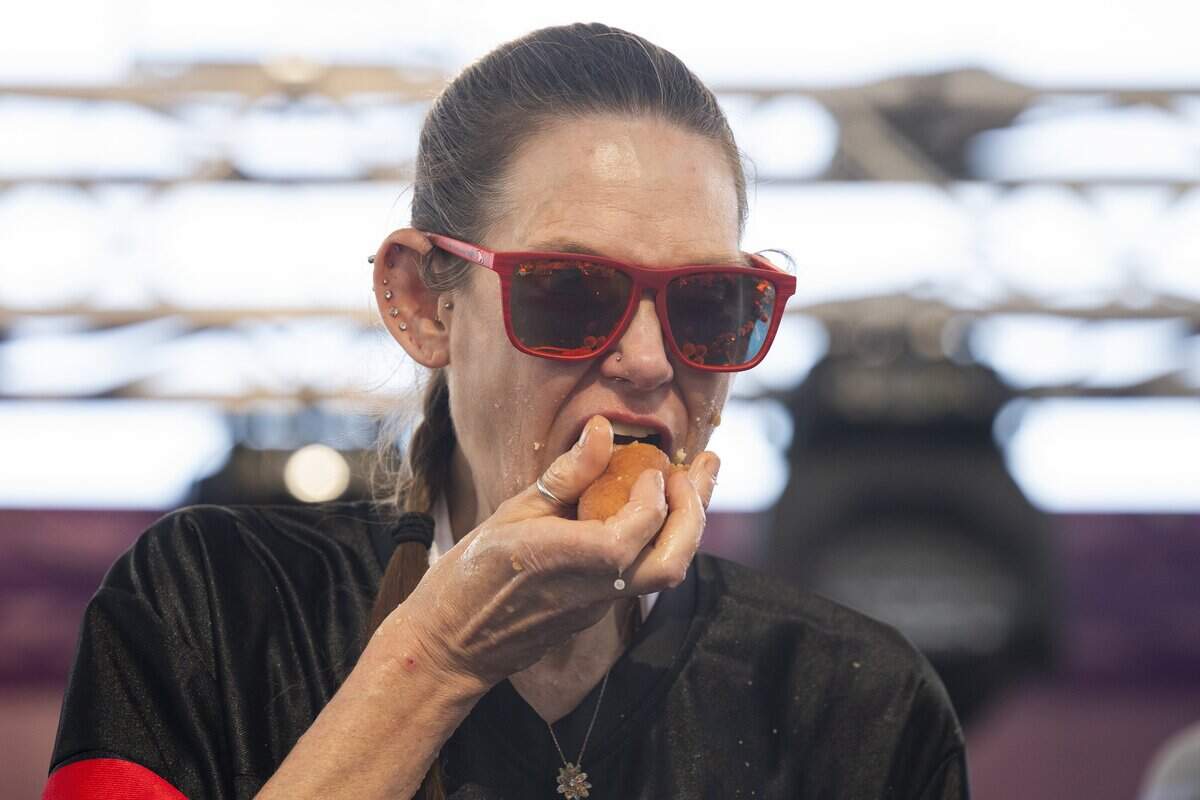 Molly Schuyler competes in Milo’s Corn Dog Eating Contest at the California State Fair in Sacramento on Saturday, July 25, 2026. Schuyler won the contest by eating 40 and a half corn dogs.