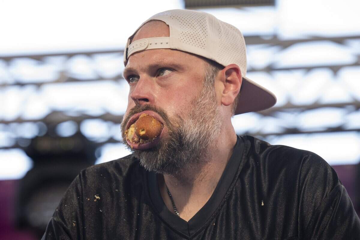 Dan Kennedy stuffs down one last corn dog as time is called during the Milo’s Corndog Eating Contest at the California State Fair in Sacramento on Saturday, July 25, 2026.