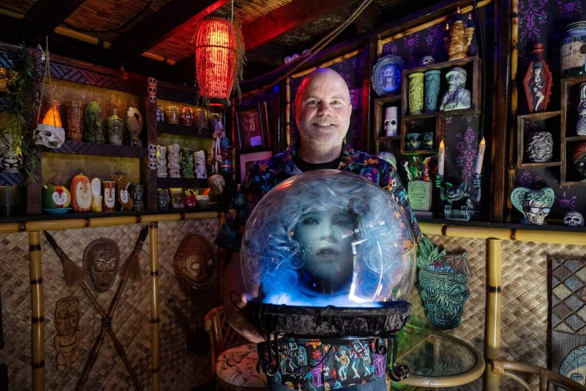 Matt Mitchell holds a replica of Madame Leota's crystal ball from Disney's "Haunted Mansion" attraction in the tiki room behind his Rancho Cordova home on Tuesday, July 7, 2026.