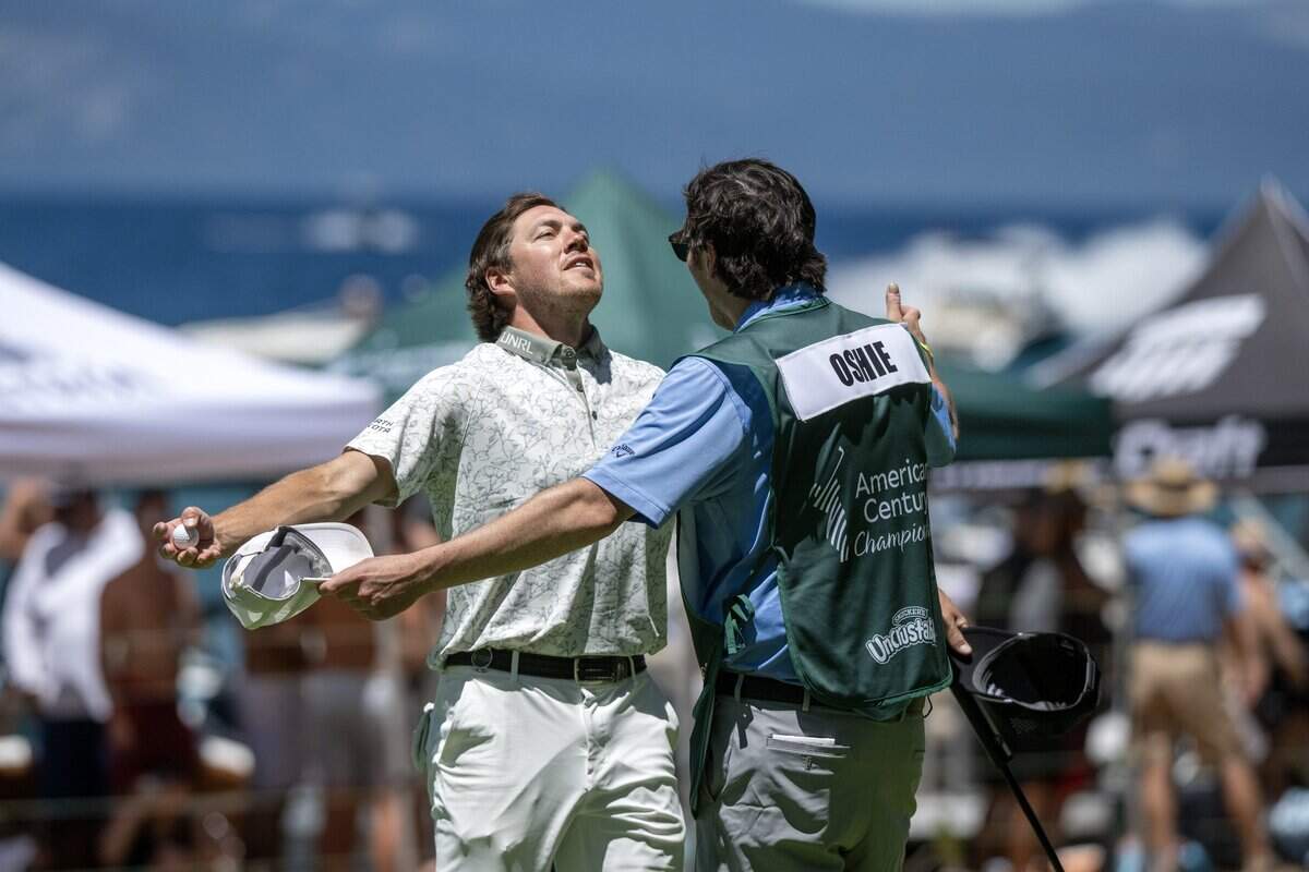 Former NHL player TJ Oshie is embraced by his caddie near the 17th hole during the American Century Championship at Edgewood Tahoe Golf Course in Stateline, Nev., on Friday, July 10, 2026.