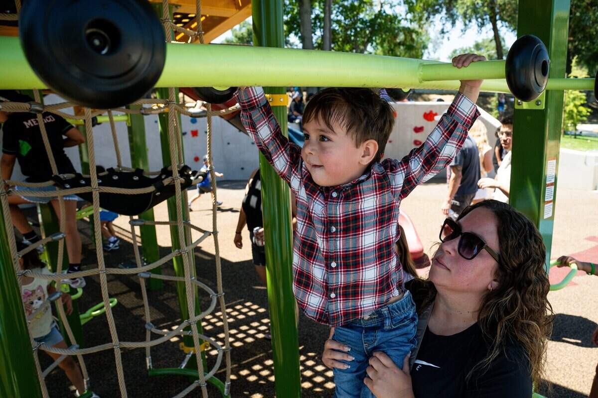 Tina Belerra and her son Josiah Belerra, 2, check out the new monkey bars at Westacre Park in West Sacramento on Thursday.