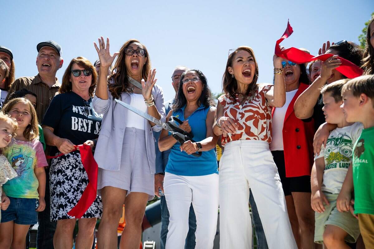 West Sacramento Mayor Martha Guerrero, center, cuts the ribbon at a ceremony for the reopening of Westacre Park in West Sacramento on Thursday.