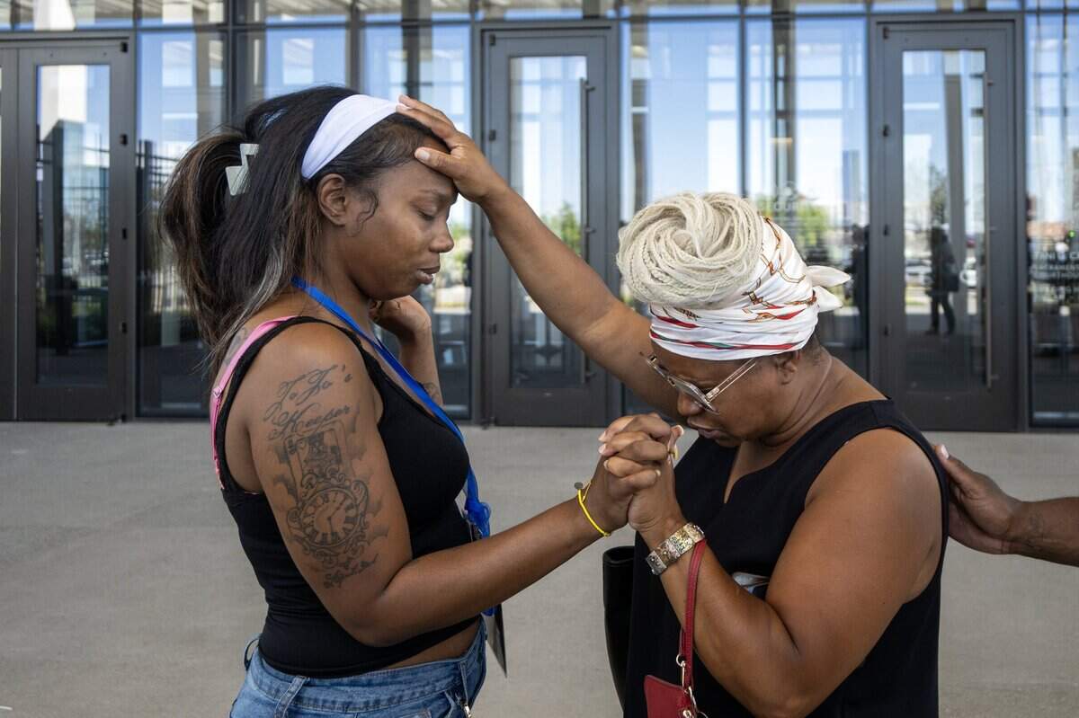 Pastor Nakisha Woods of Keys to Victory Ministry prays with Johntezha Alexander outside the Tani G. Cantil-Sakauye Sacramento County Courthouse in Sacramento after a judge declared a mistrial in the K Street mass shooting trial on Tuesday, July 21, 2026.