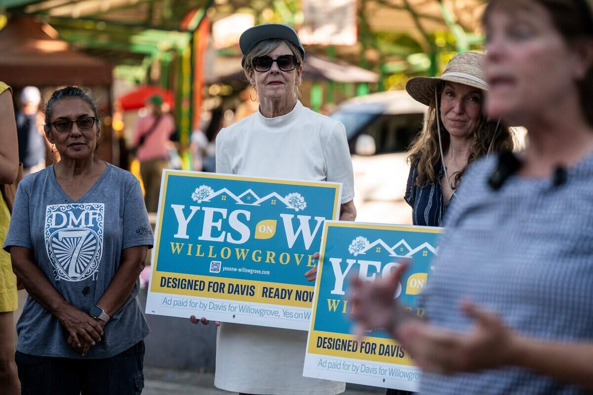 Davis Mayor Donna Neville, center, attends the Measure W campaign launch event at Davis Farmer's Market on Wednesday. The proposal would allow construction of 1,250 housing units.