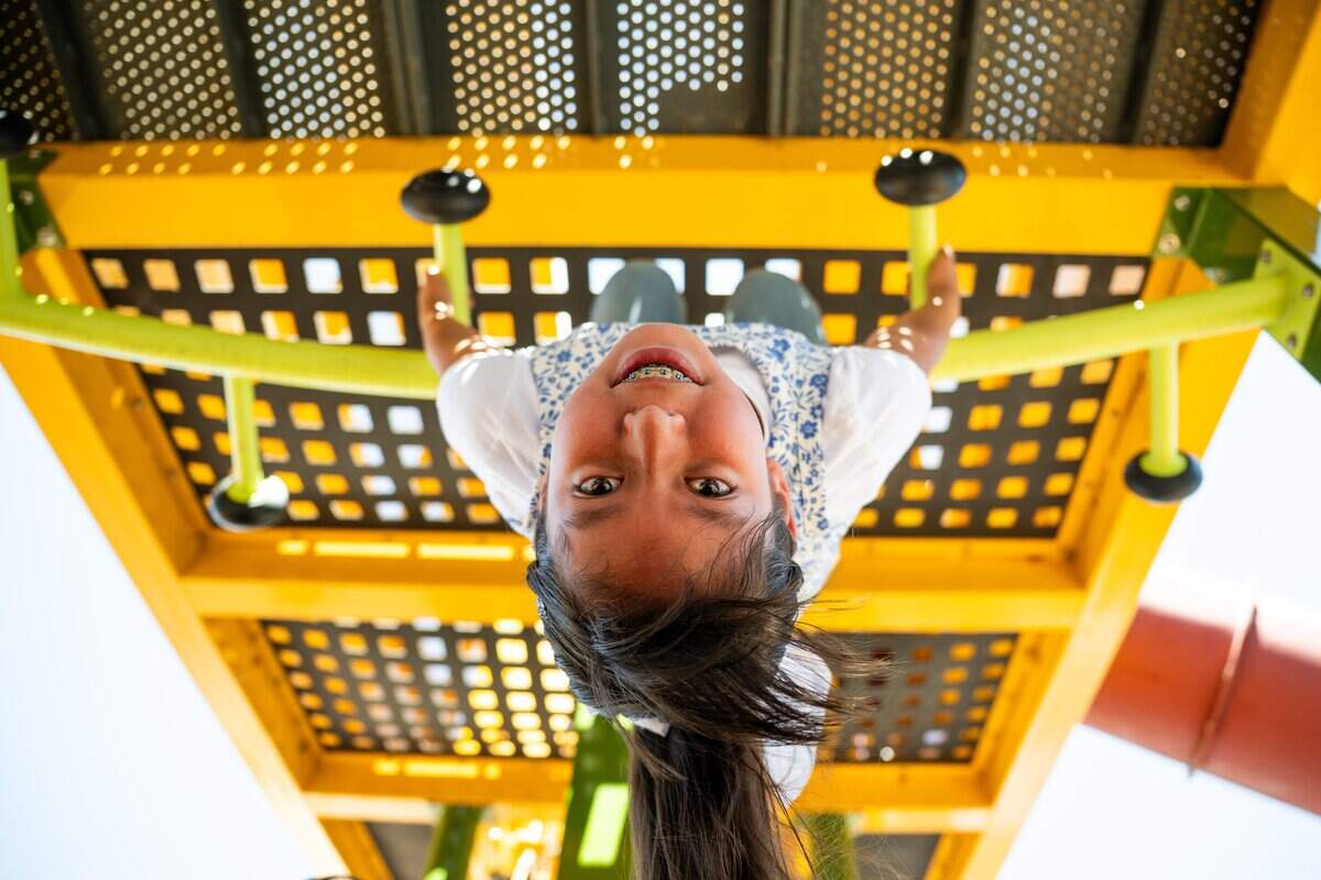 A member of the Hen House Summer Camp checks out the new monkey bars at Westacre Park in West Sacramento on Thursday.