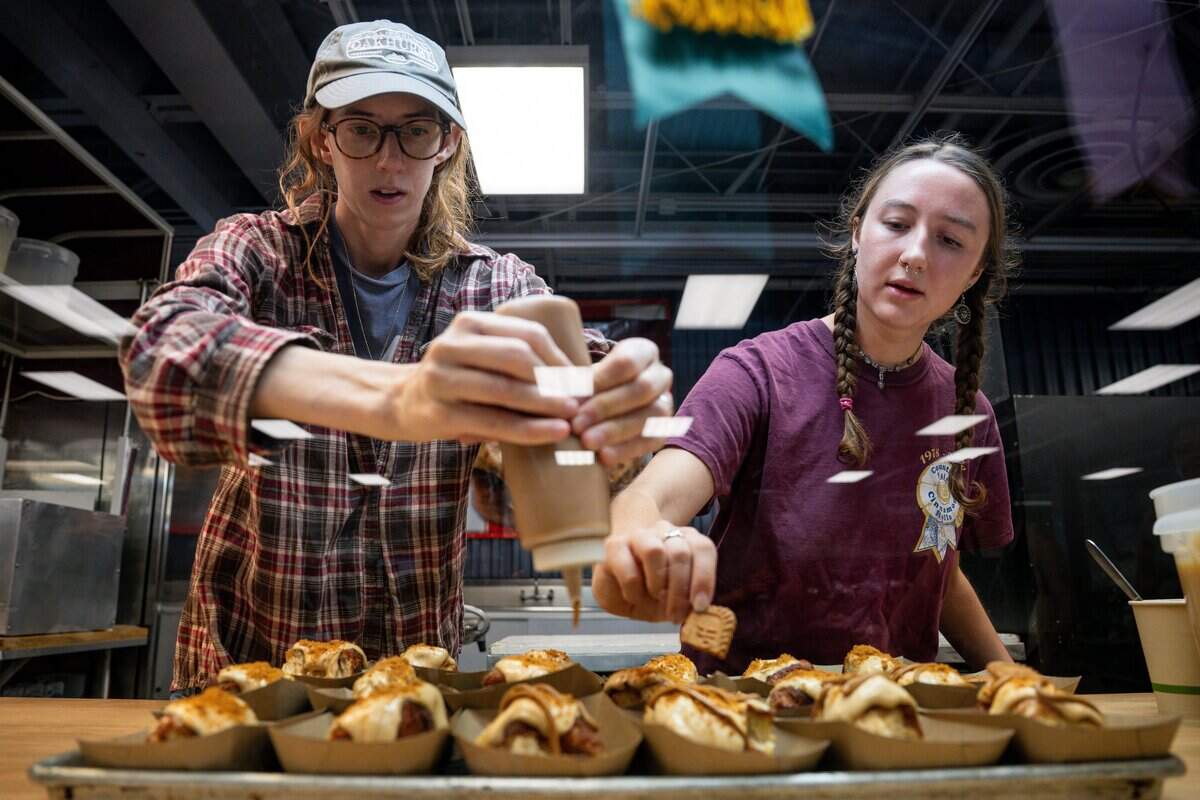 Jaecie Madaus, left, and Abigail Madaus of Country Fair Cinnamon Rolls prepare desserts during the California State Fair media day on Cal Expo in Sacramento on Wednesday, July 15, 2026.