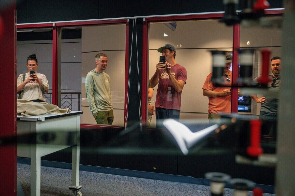 Audience members check out the IMAX movie projector in Esquire IMAX Theatre in Sacramento on Friday, July 17, 2026.