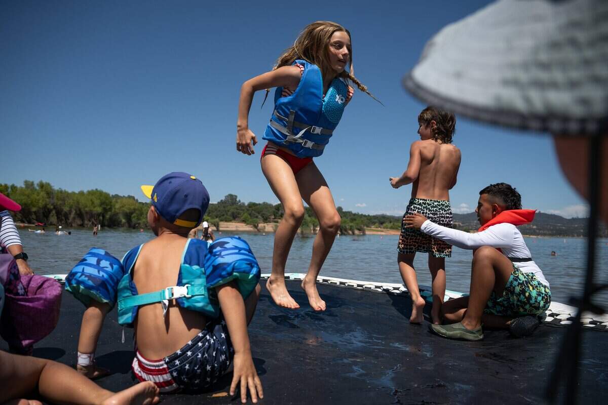 Nevaeh Solbos, 10, center, jumps on a water trampoline at the Folsom Lake State Recreation Area in Granite Bay on Tuesday.