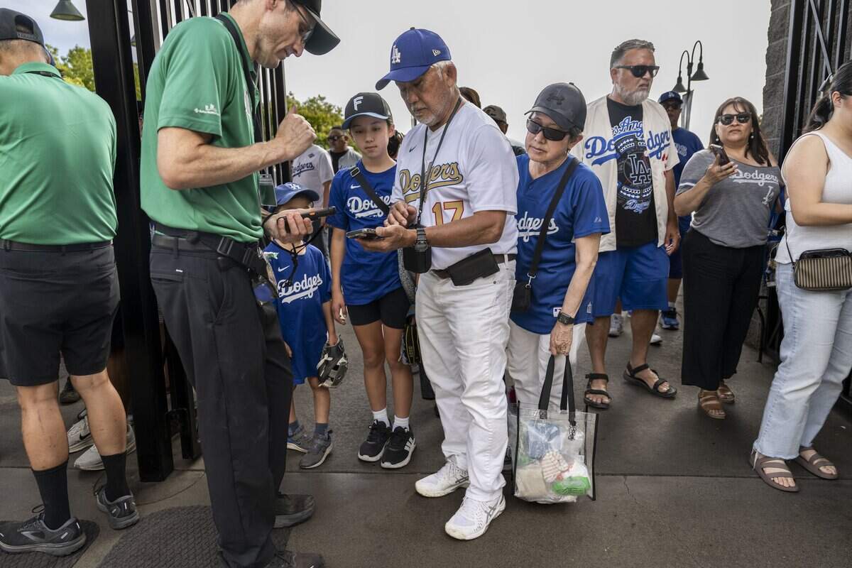 Stockton resident Jack Funamura, wearing the jersey of Los Angeles Dodgers star Shohei Ohtani, presents his family's tickets to see the Dodgers play the Athletics at Sutter Health Park in West Sacramento on Monday, June 29, 2026.