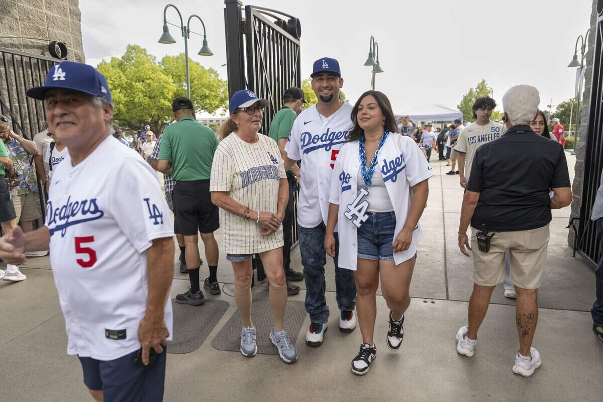 Los Angeles Dodgers fans arrive at Sutter Health Park in West Sacramento before Monday’s game against the Athletics. Thousands of Dodgers supporters traveled to the Sacramento region for the three-game series, filling hotels, restaurants and entertainment districts with a sea of blue.