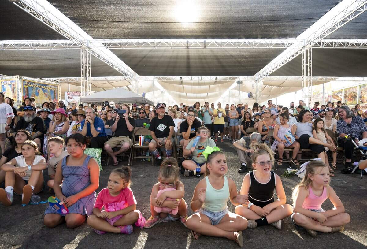 Fair goers take a break to watch the Milo’s Corn Dog Eating Contest at the California State Fair in Sacramento on Saturday, July 25, 2026.