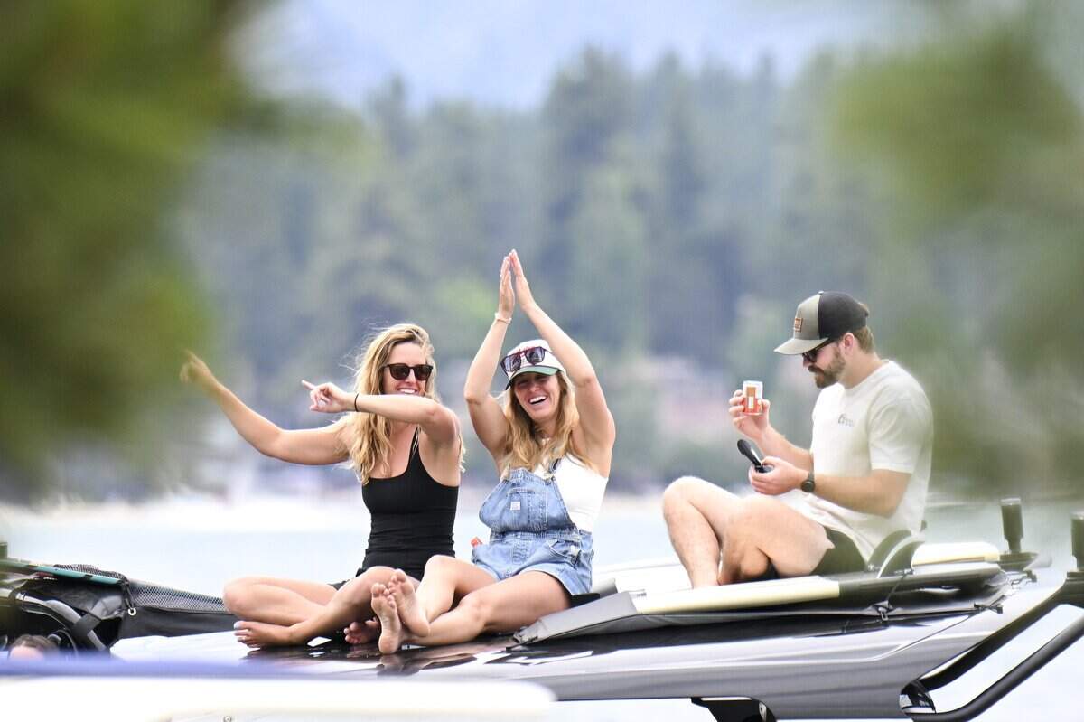 Spectators dance while sitting on top of a boat next to the 17th hole during the American Century Golf Tournament in Stateline, Nev. on Sunday, July 12, 2026.