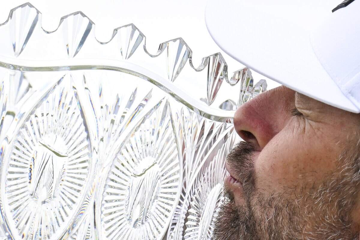 Former professional tennis player Mardy Fish kisses the trophy after winning the American Century Golf Tournament in Stateline, Nev., on Sunday. It is the third time he’s won the biggest celebrity tournament in golf.