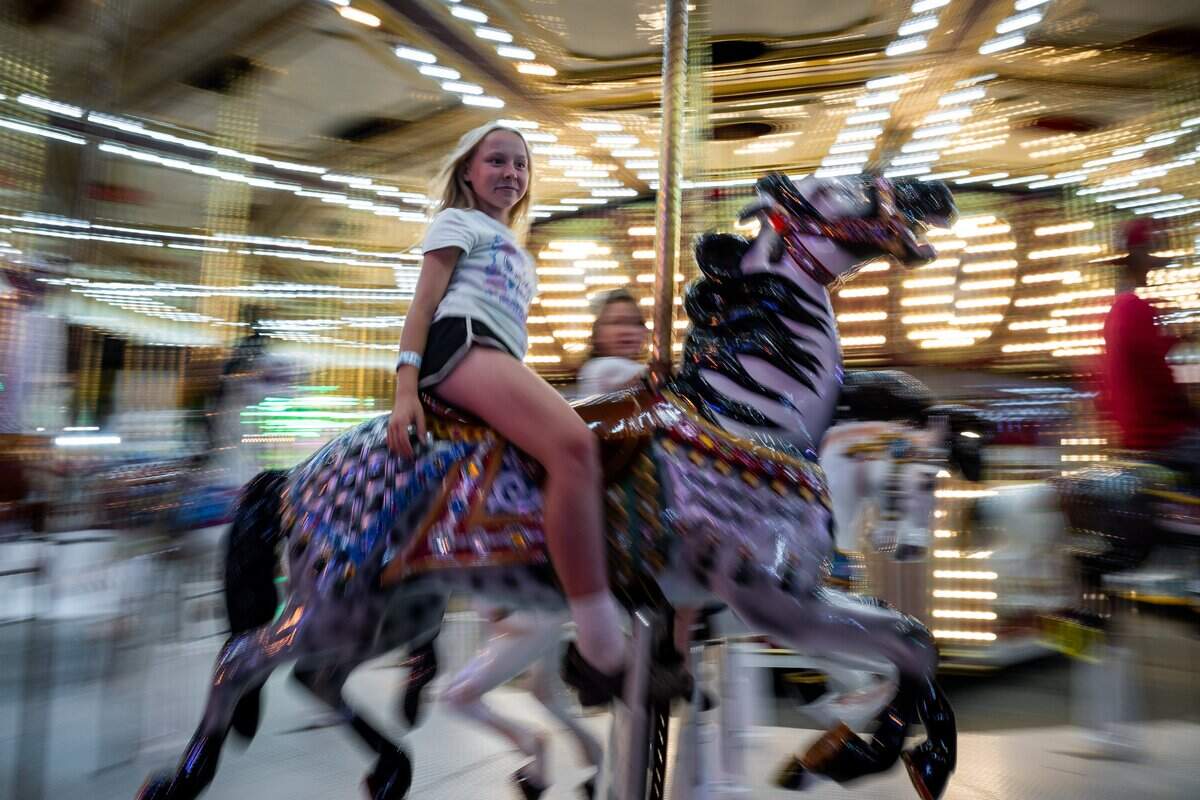 Valerie Brown, 11, tries out the merry-go-round at the California State Fair at Cal Expo in Sacramento on Monday, July 20.