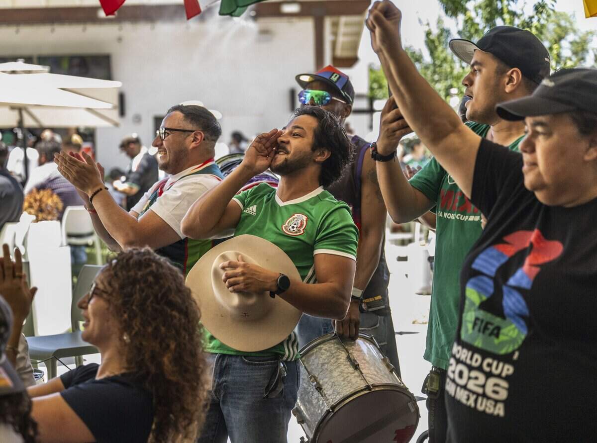 Jorge Jimenez, center, cheers with other fans at a watch party at Garden at the Line in Sacramento as Mexico scores the first goal of the World Cup on Thursday, June 11.