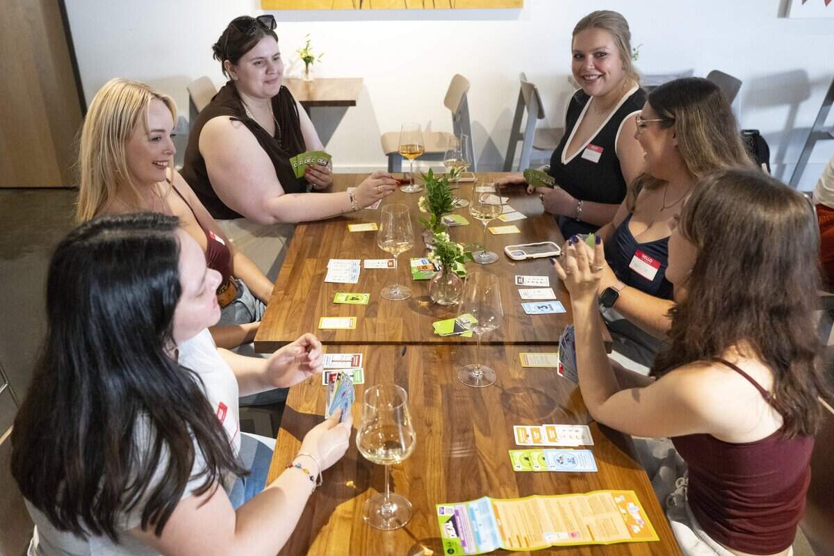 From left, Kimerly Chavez, Julia Dejardin, Shelby Brendle, Cassidy McCallum, Anissa Olona and Teddy Brooks play the Monopoly Deal card game, as Girls Night Out Sacramento gathers at Alma Wine Bar in Sacramento on Tuesday, July 28, 2026.