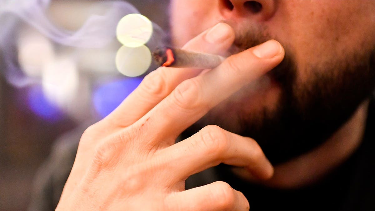 Man smoking marijuana in public