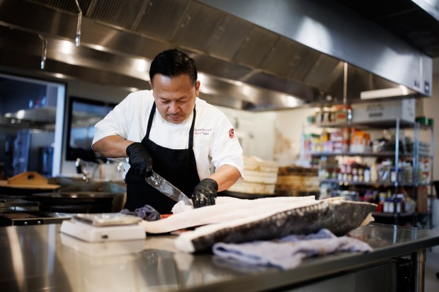 Chef Daniel Sudar prepares a sea bass in the kitchen at Asia Live, a new restaurant in the Westfield Valley Fair mall in Santa Clara, Calif., on Wednesday, June 24, 2026. (Dai Sugano/Bay Area News Group)