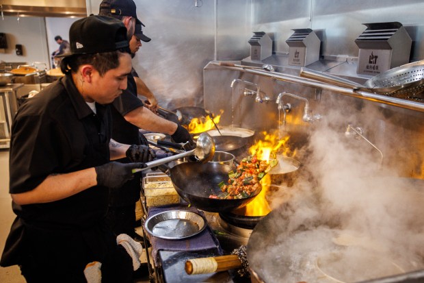 Kung Pao "firecracker" chicken is cooked over roaring open flames inside the kitchen of Asia Live, a new restaurant in the Westfield Valley Fair mall in Santa Clara, Calif., on Wednesday, June 24, 2026. (Dai Sugano/Bay Area News Group)