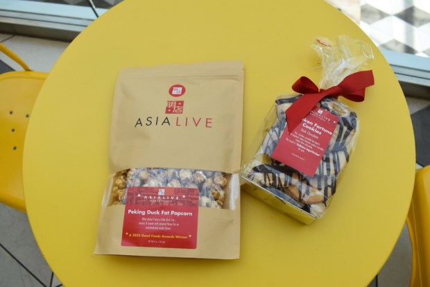 Peking duck fat popcorn ($15) and Broken fortune cookies with dark chocolate ($13) are two of the tasty snacks on offer at Asia Live's retail shop at the front of the restaurant. (Kate Bradshaw/Bay Area News Group)