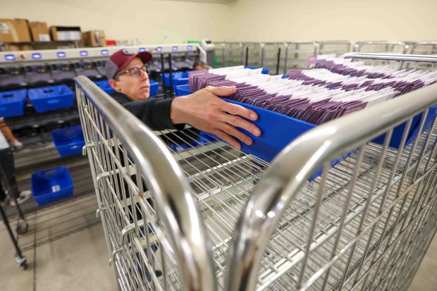 Elections seasonal clerk Kevin Smith places bins of mail-in ballots in a cart after they were scanned at the Contra Costa County Registrar of Voters in Martinez, Calif., Friday, May 29, 2026. (Ray Chavez/Bay Area News Group)